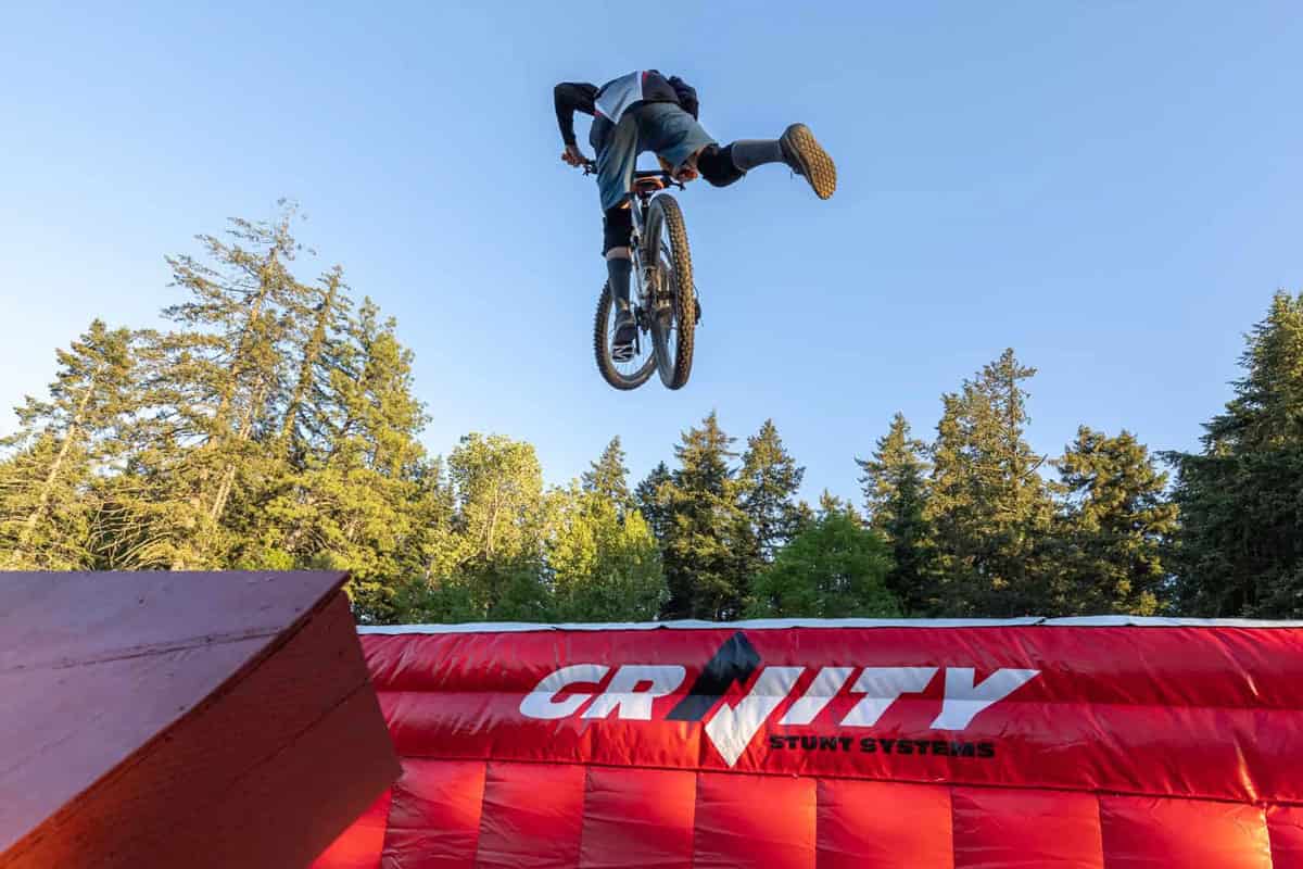 A biker attempting a complex stunt on a Gravity airbag