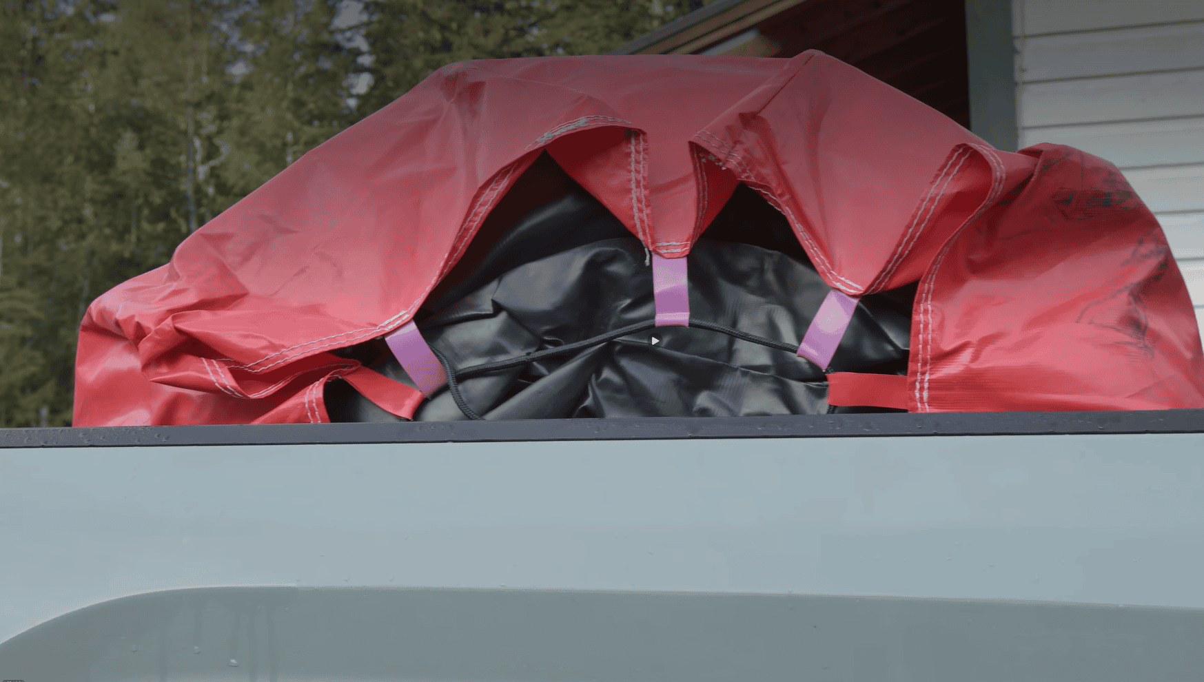 The rolled up airbag tethered down in a truck