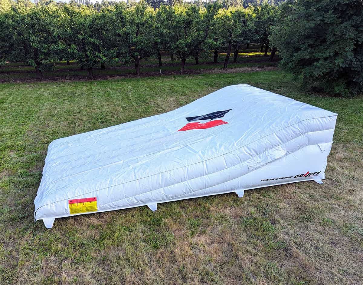 White inflatable stunt landing airbag positioned outdoors for motocross and BMX landing practice